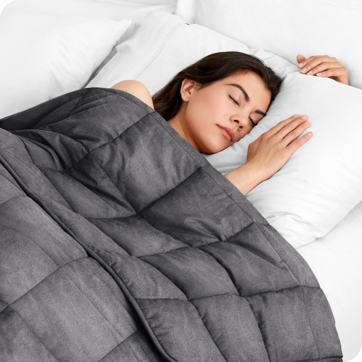 A woman sleeping with a weighted blanket over her body