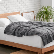 A weighted blanket draped over a bed