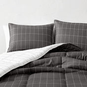 Gray grid patterned bedding set on a bed