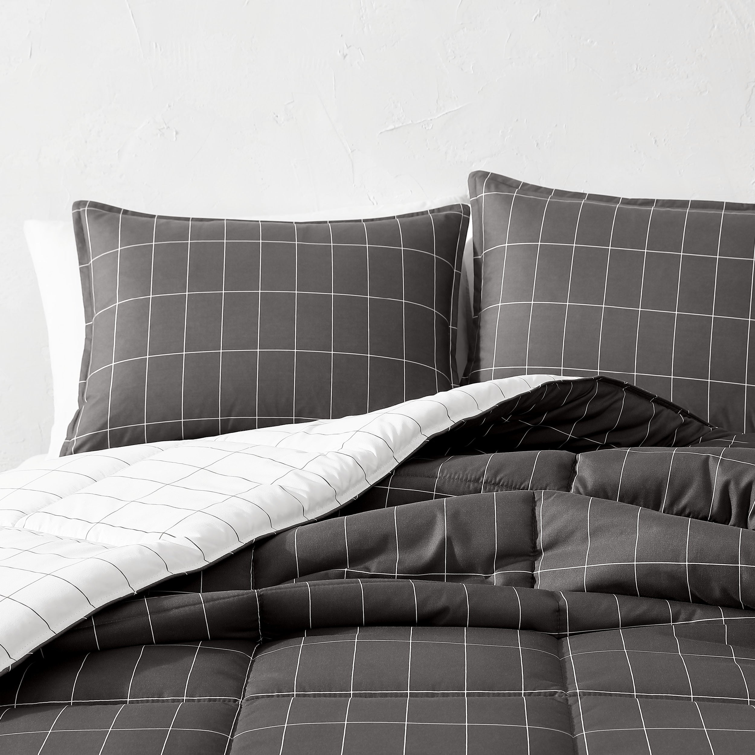 Gray grid patterned bedding set on a bed