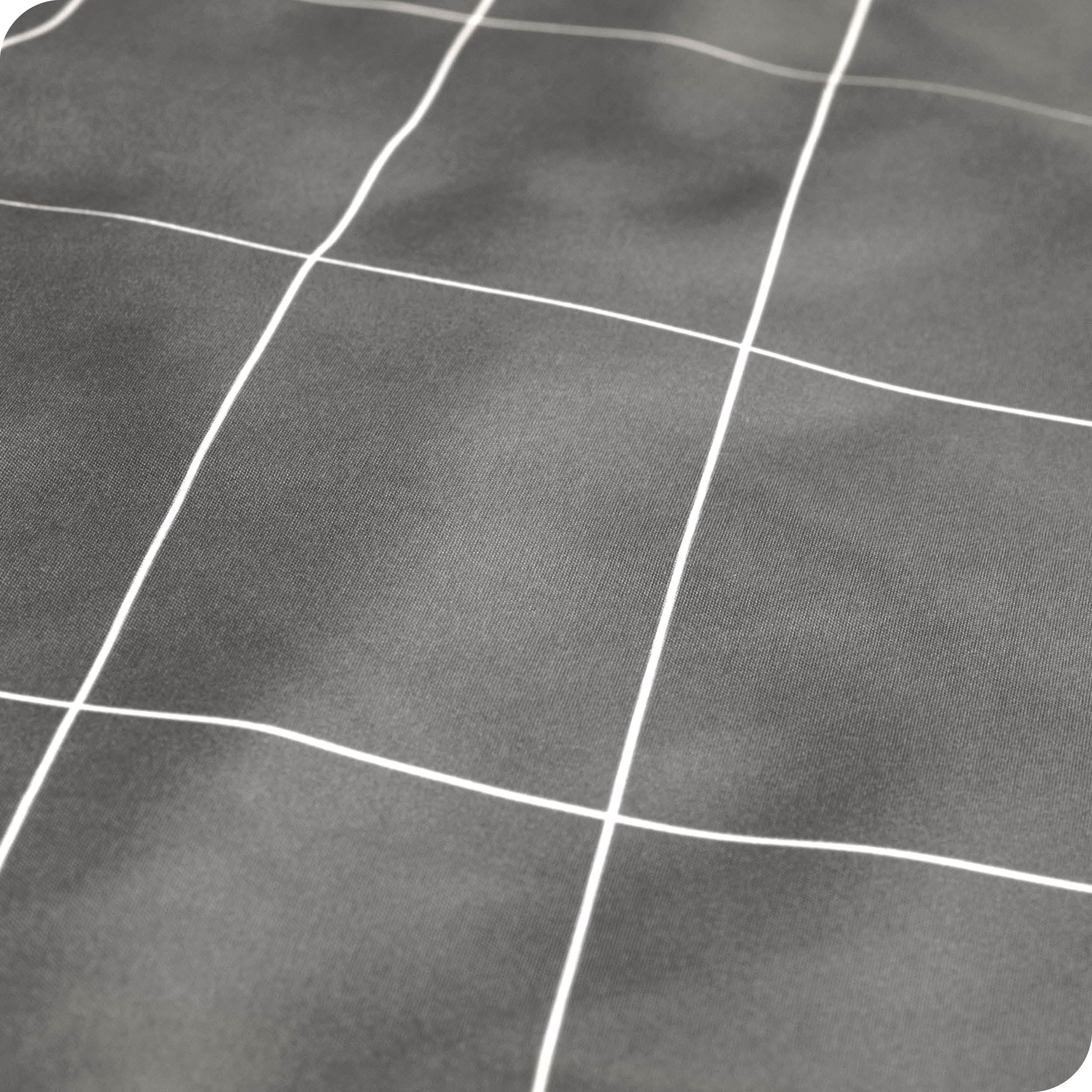 Close up of a printed microfiber sheet showing the grid pattern and texture