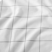 White fabric with a thin black grid pattern, shown in a close-up texture view with soft folds.