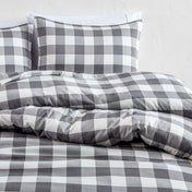Gray and white checkered bedding set on a bed