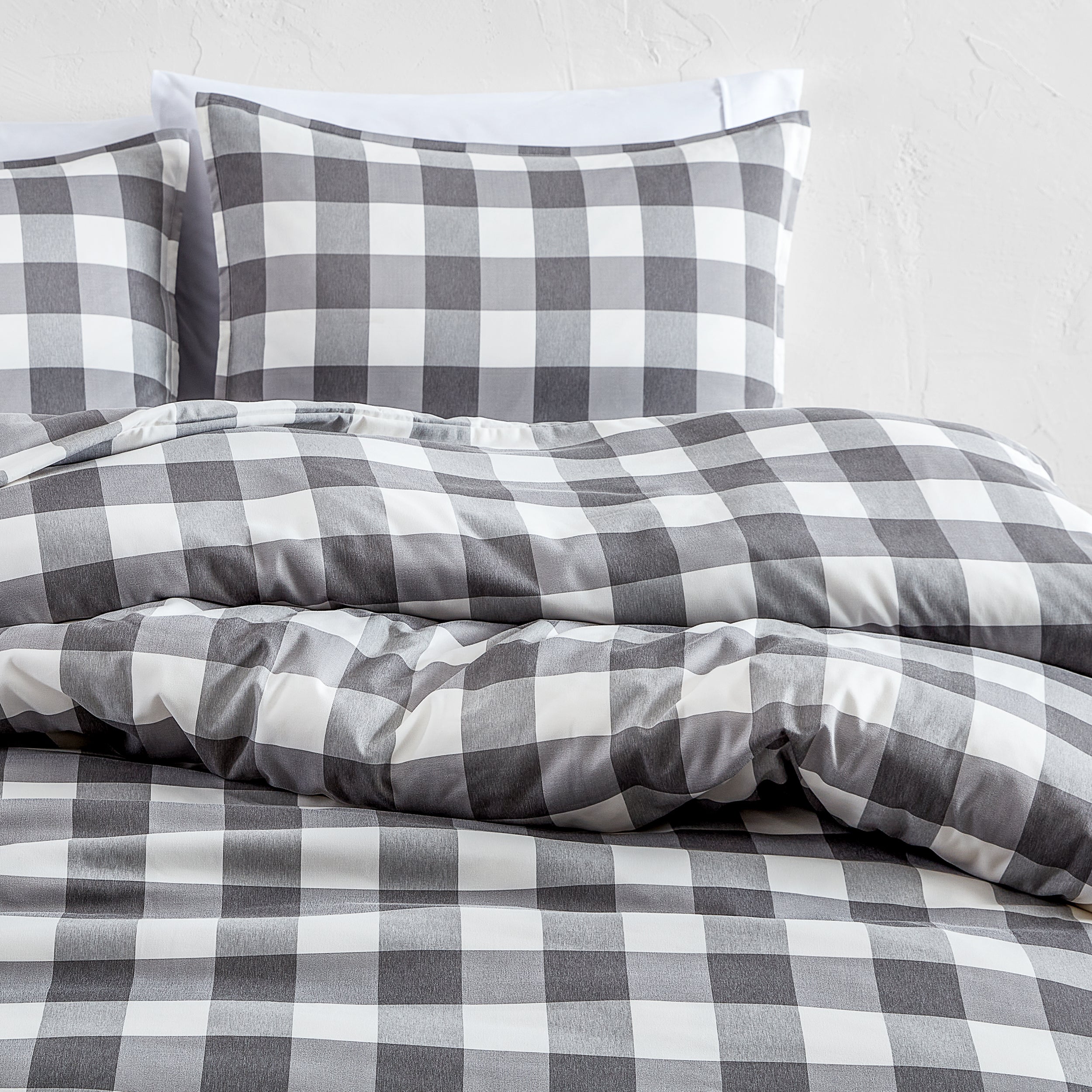 Gray and white checkered bedding set on a bed