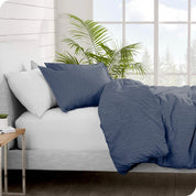 Side view of a bed made with a flannel duvet cover