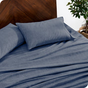 A close view of a flannel sheet set on a modern bed with two pillows.