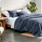 Relaxing room scene showing a indigo linen duvet cover set laid out over the bed