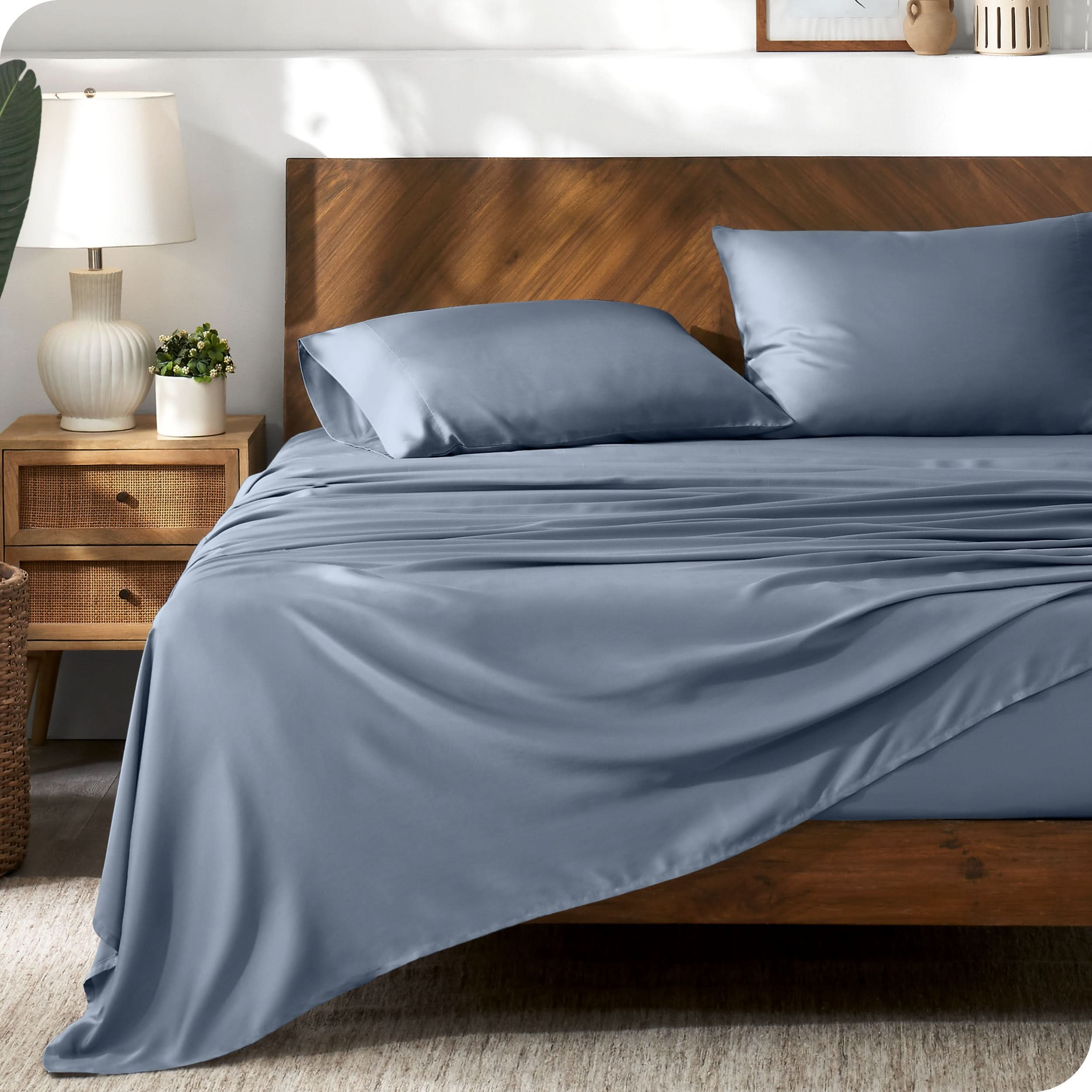 TENCEL™ sheet set on a bed. The flat sheet is draped over the side and end of the bed.