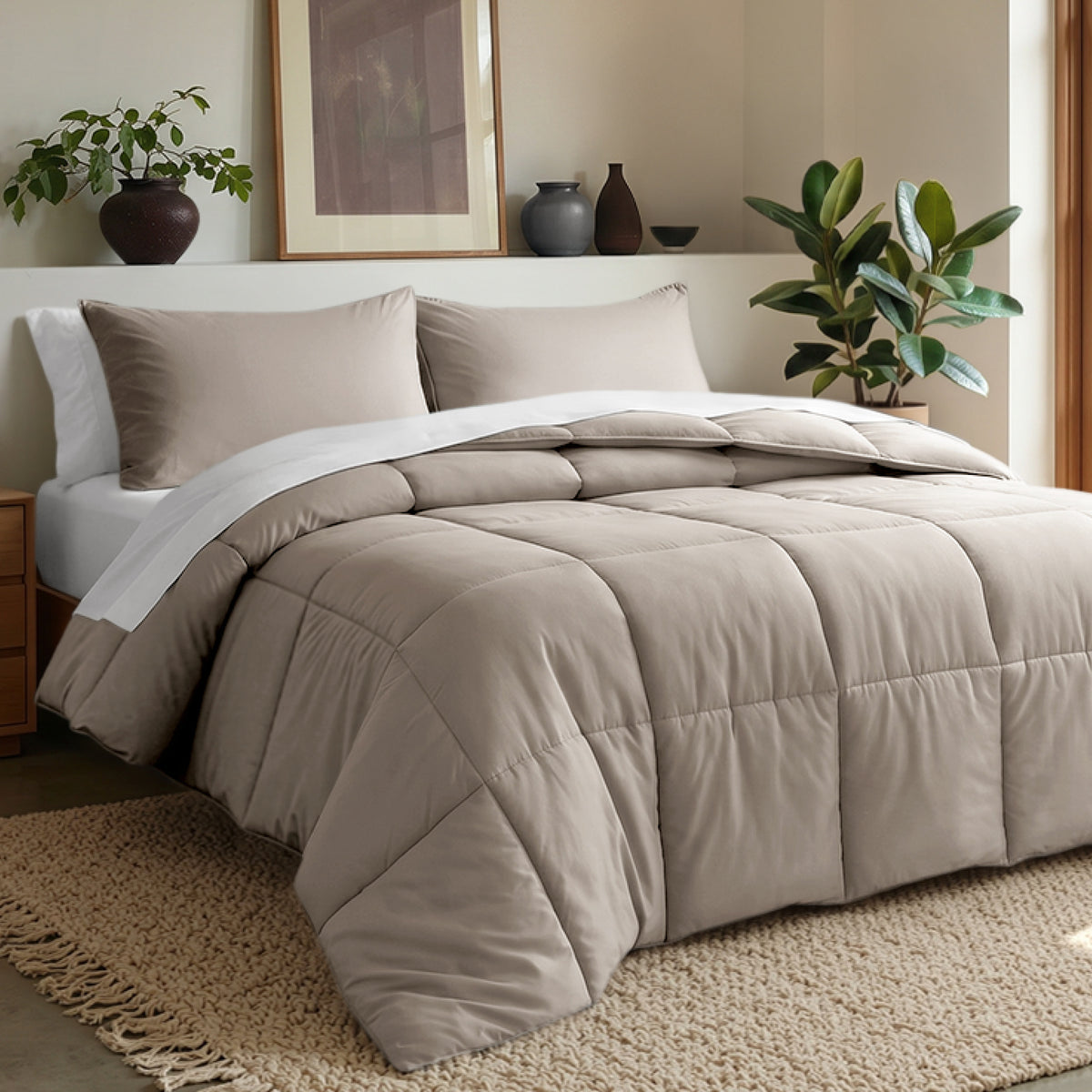 Comforter set on a bed in a bedroom with plants and decor.