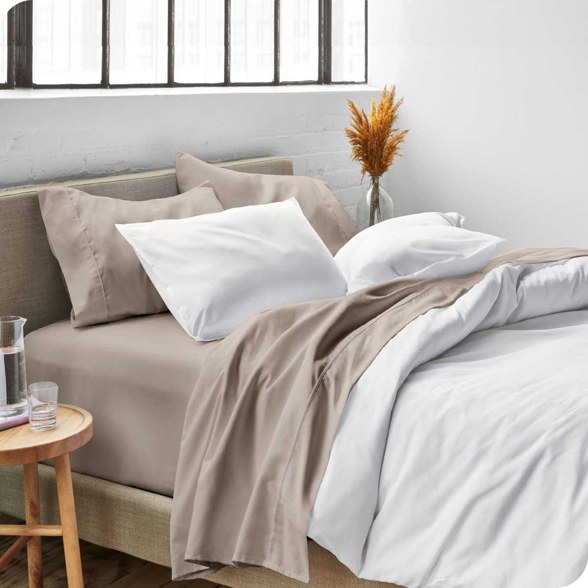 Sheets and a duvet cover on a bed in a bright bedroom