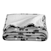 Folded blanket with bear pattern on a white background