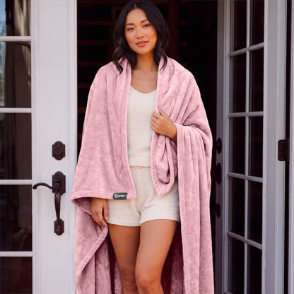 A woman standing with a microplush blanket wrapped around her