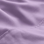 A close-up of microfiber fabric with soft folds and a visible stitched seam.
