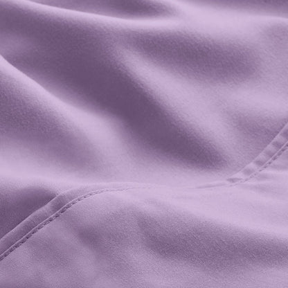 A close-up of microfiber fabric with soft folds and a visible stitched seam.