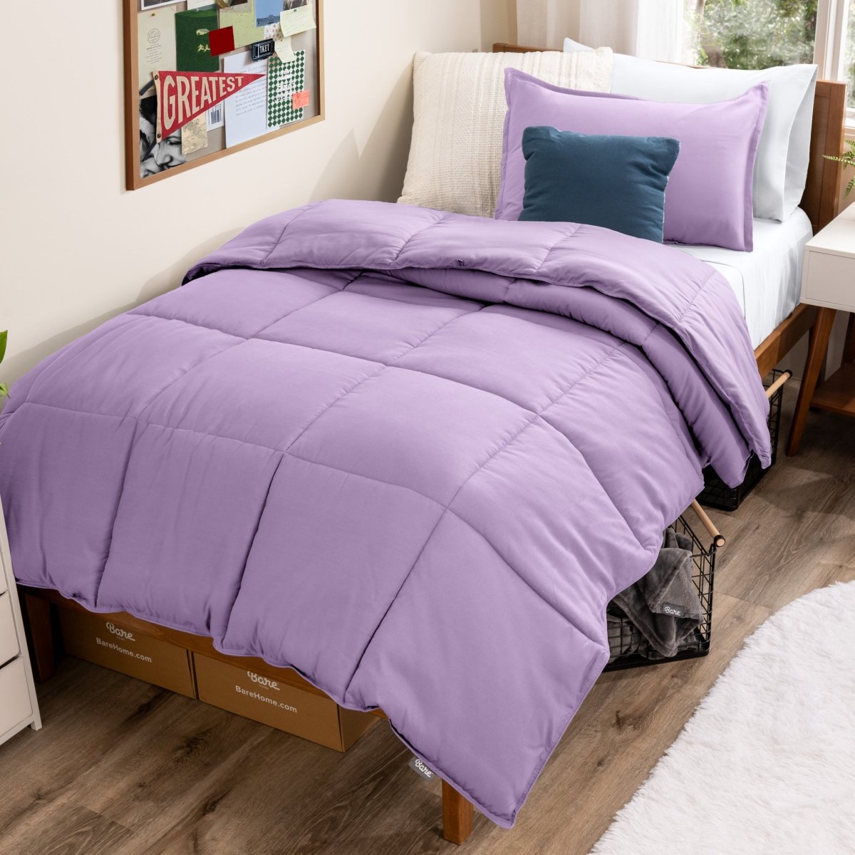 Bed with comforter and pillows in a dorm room