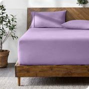 A bed with a fitted sheet and matching pillowcases