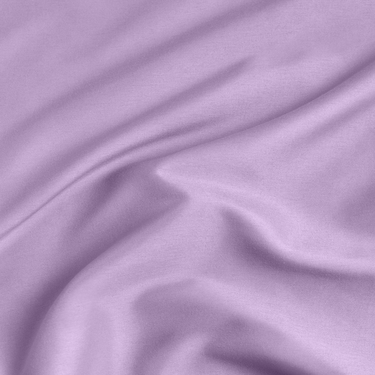 A close-up of a fitted sheet with a label printed with the word 'BOTTOM' in white.