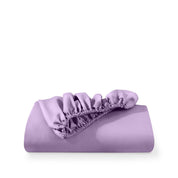 A fitted sheet folded neatly with the all around elastic showing