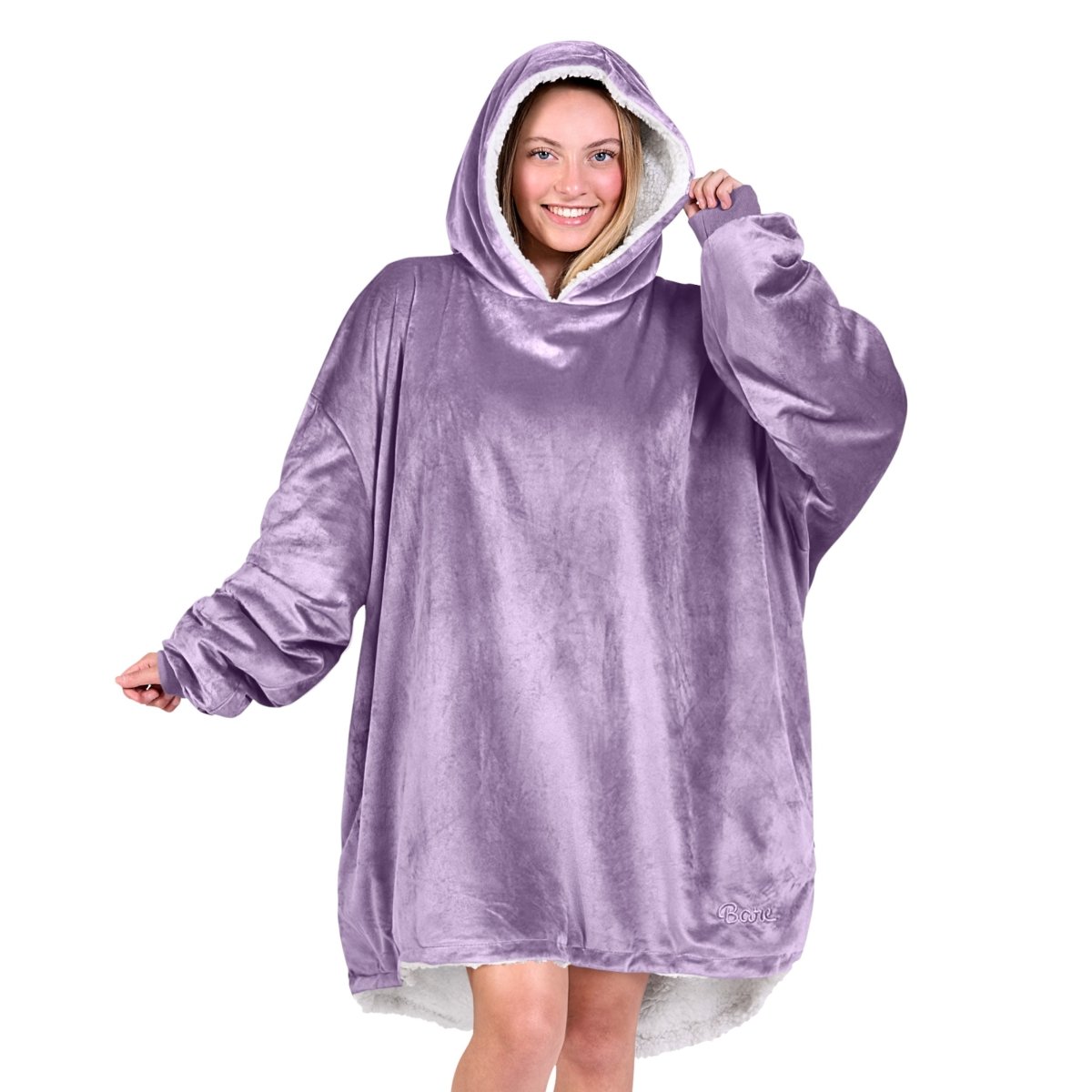 An adult with a hooded wearable blanket on