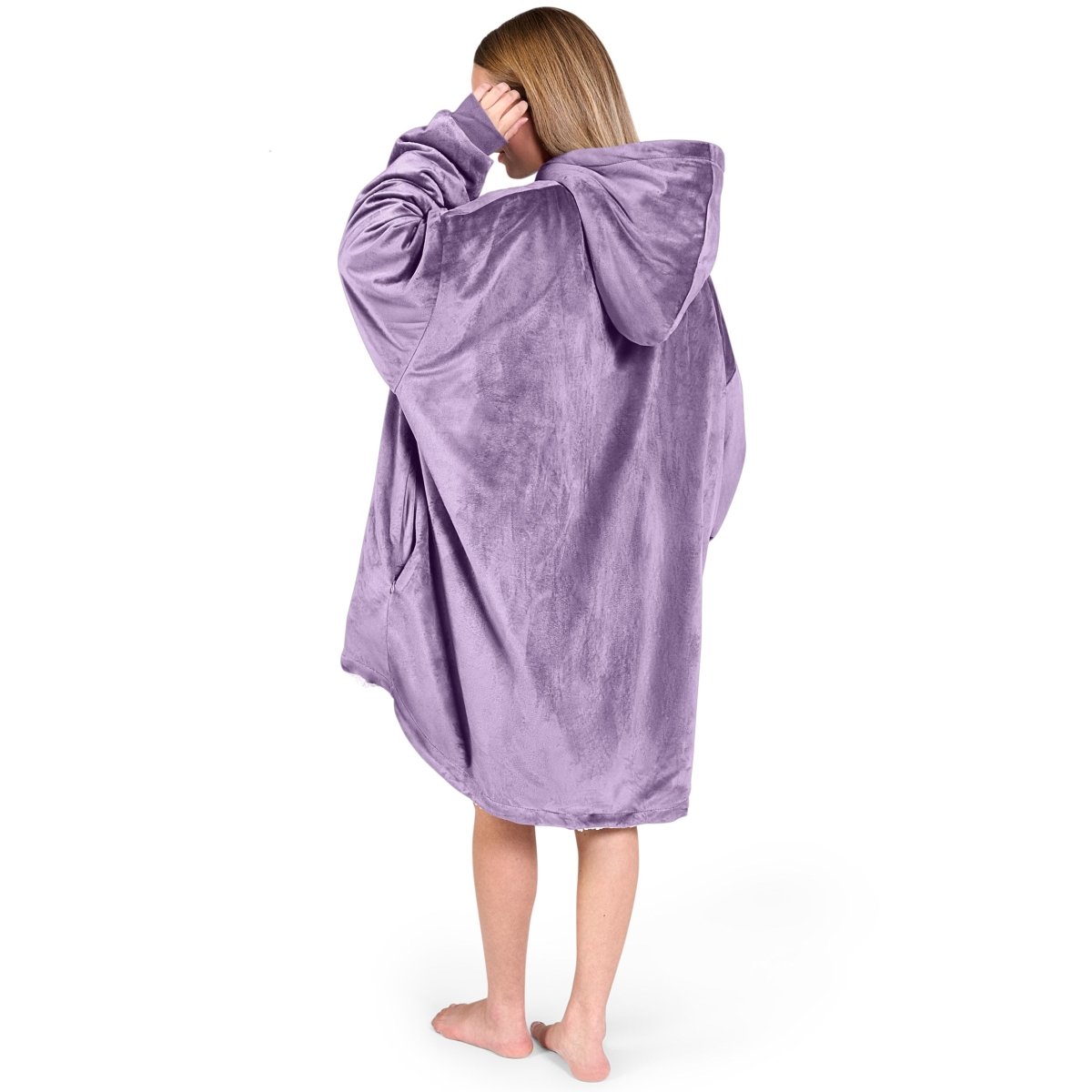 An adult with a sherpa wearable blanket on