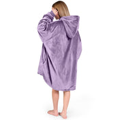 An adult with a sherpa wearable blanket on