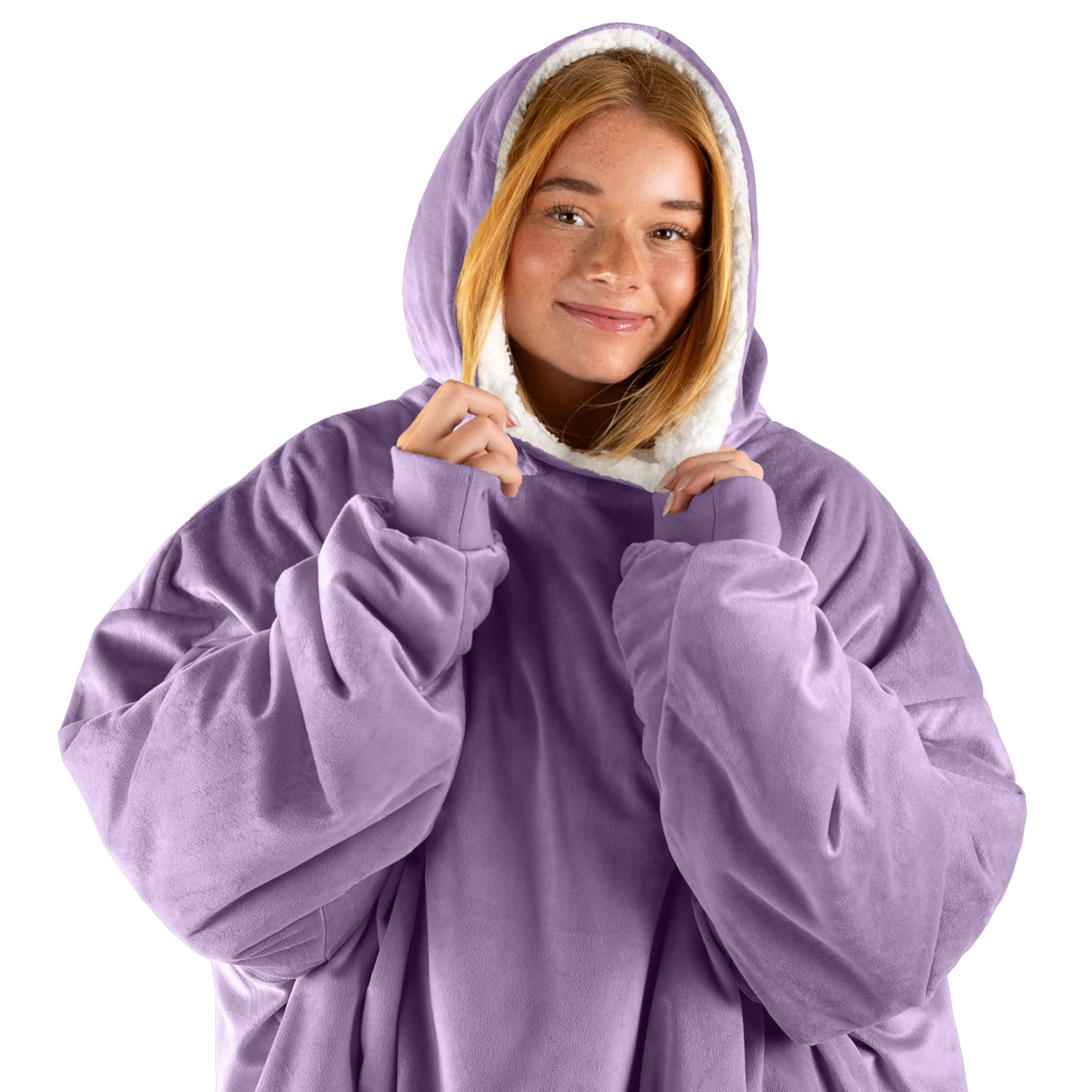 An adult with a wearable blanket on