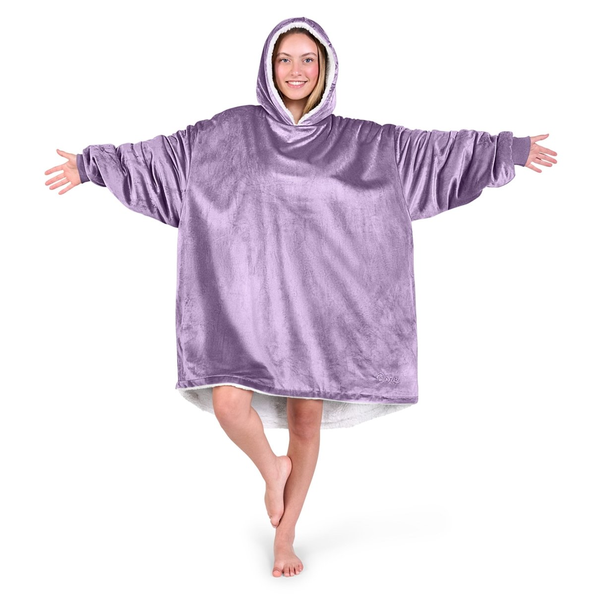 An adult with a hooded wearable blanket on