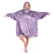 An adult with a hooded wearable blanket on