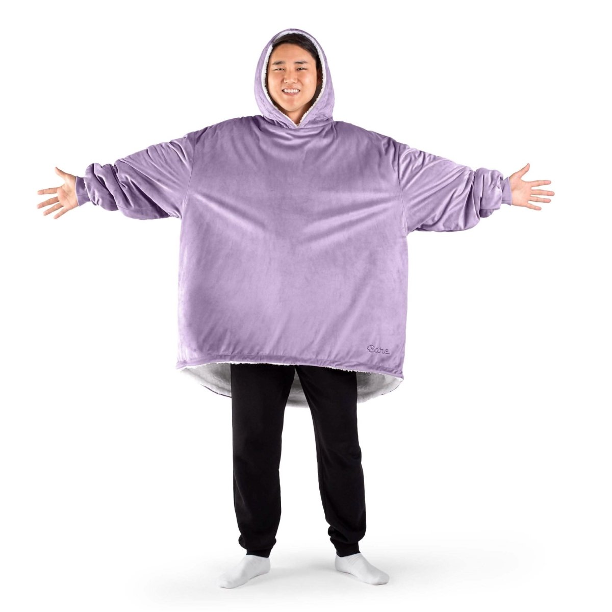 An adult with a sherpa wearable blanket on