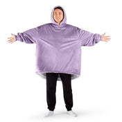 An adult with a sherpa wearable blanket on