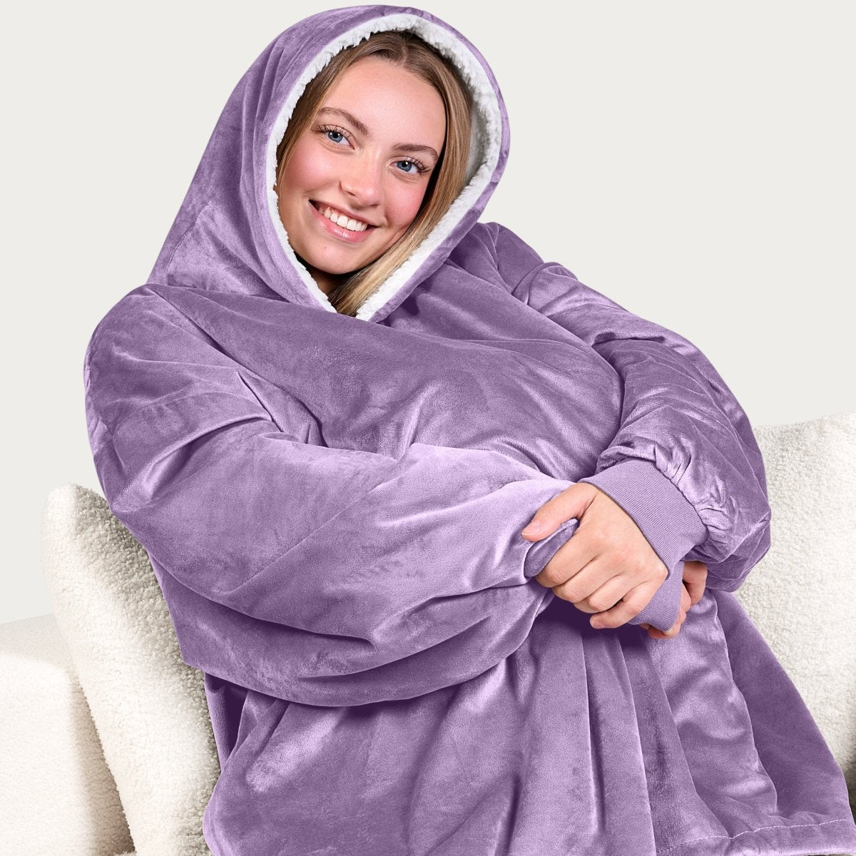 An adult with a sherpa wearable blanket on