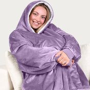 An adult with a sherpa wearable blanket on