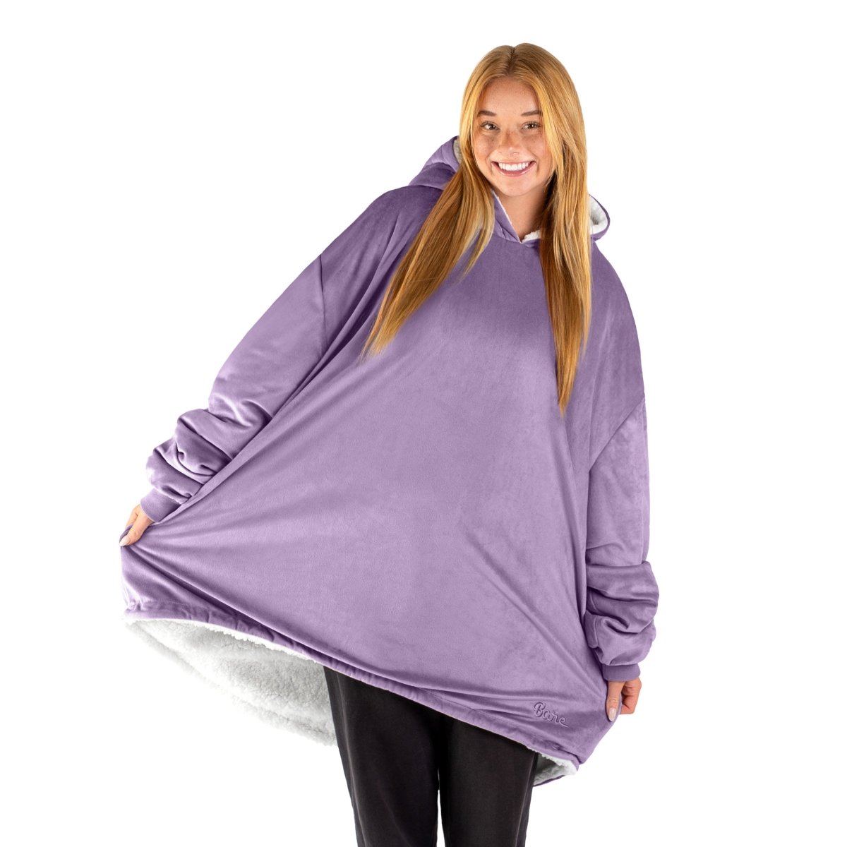 An adult with a sherpa wearable blanket on