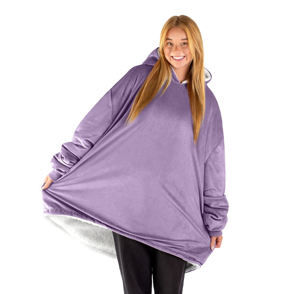 An adult with a sherpa wearable blanket on