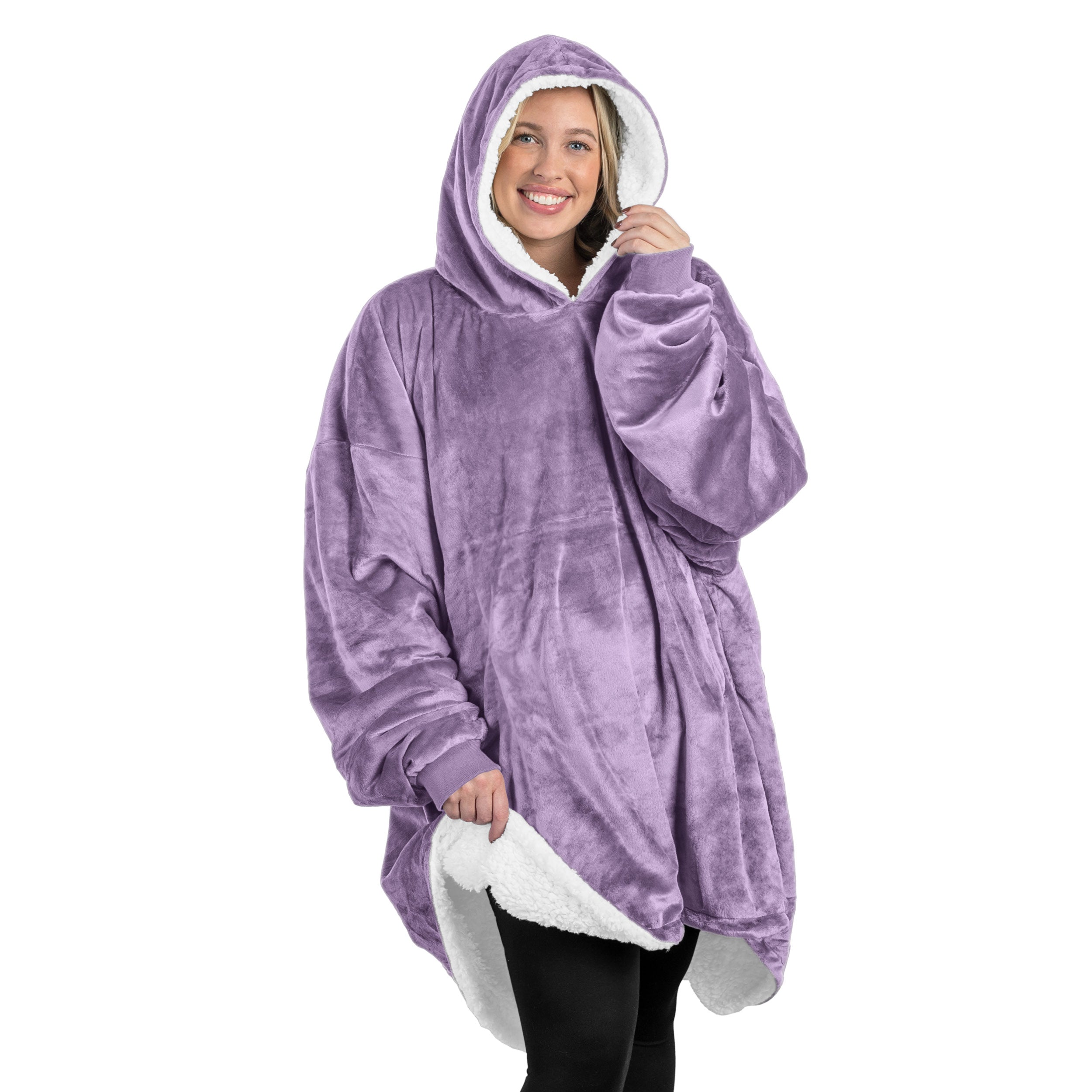A oversized sherpa wearable blanket with a hood on a woman.