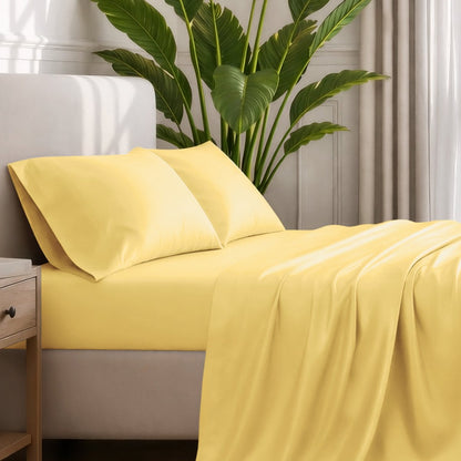 Ultra-soft sheets and pillowcases on a bed with a plant in the background