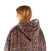 An adult with a sherpa wearable blanket on