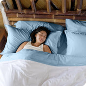 A woman sleeping in a bed made with bamboo sheets