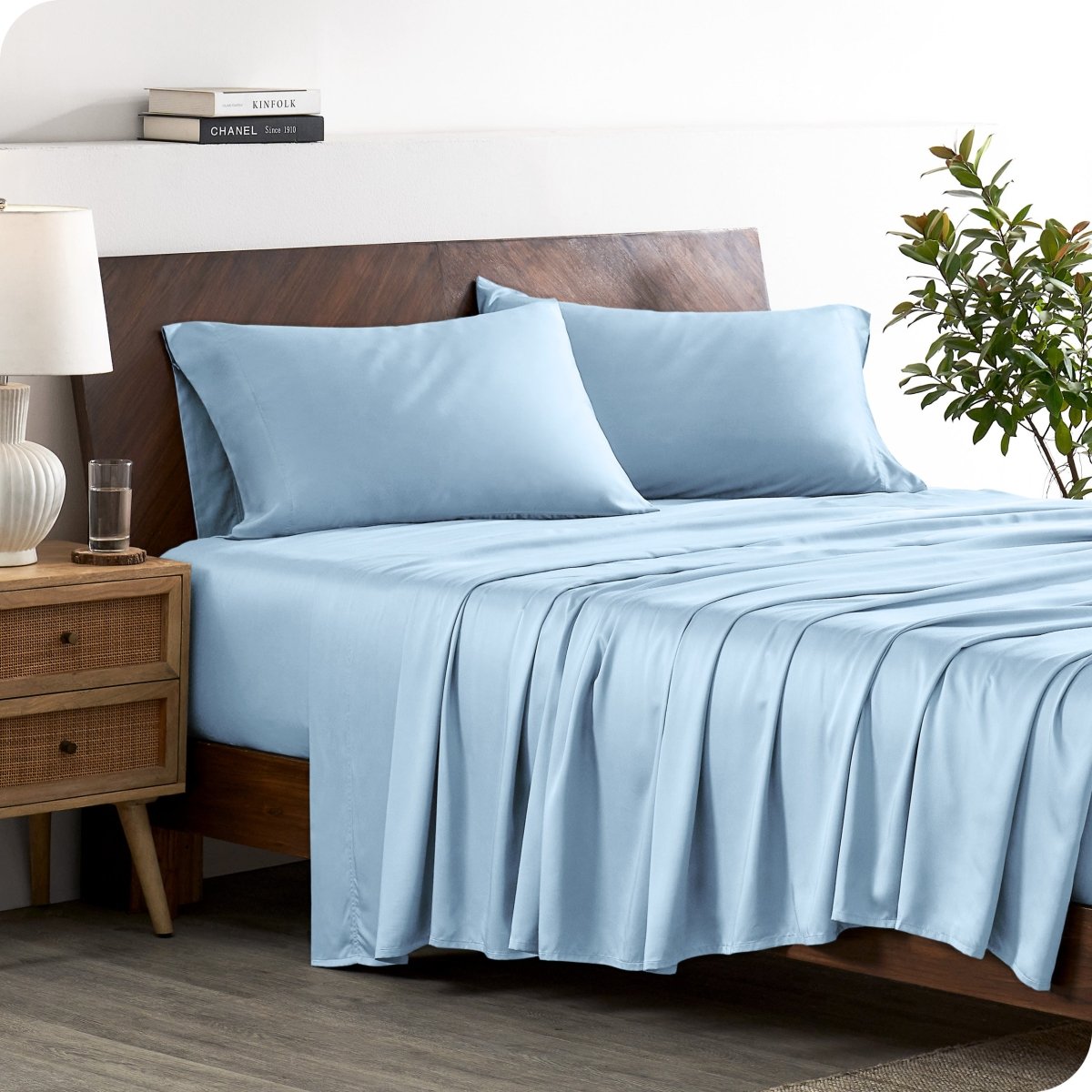 A stylish bed with bamboo sheets and pillowcases, showcasing a sophisticated and elegant bedroom setting.
