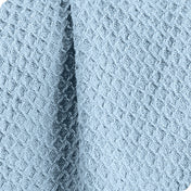 Close up of the fabric of a cotton waffle blanket