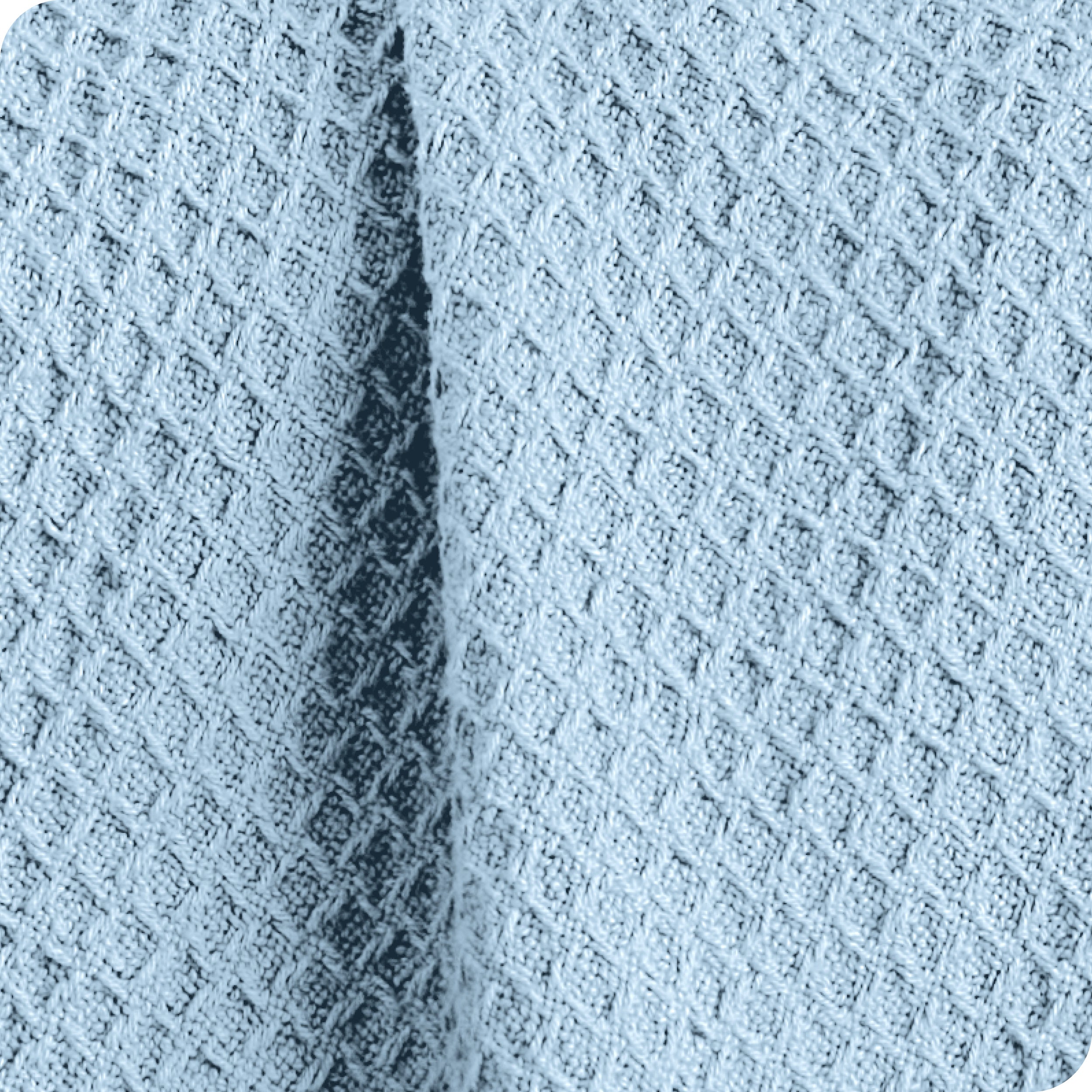 Close up of the fabric of a cotton waffle blanket