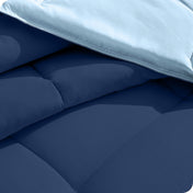 Close up of the reversible comforter showing the box stitching and the two colors