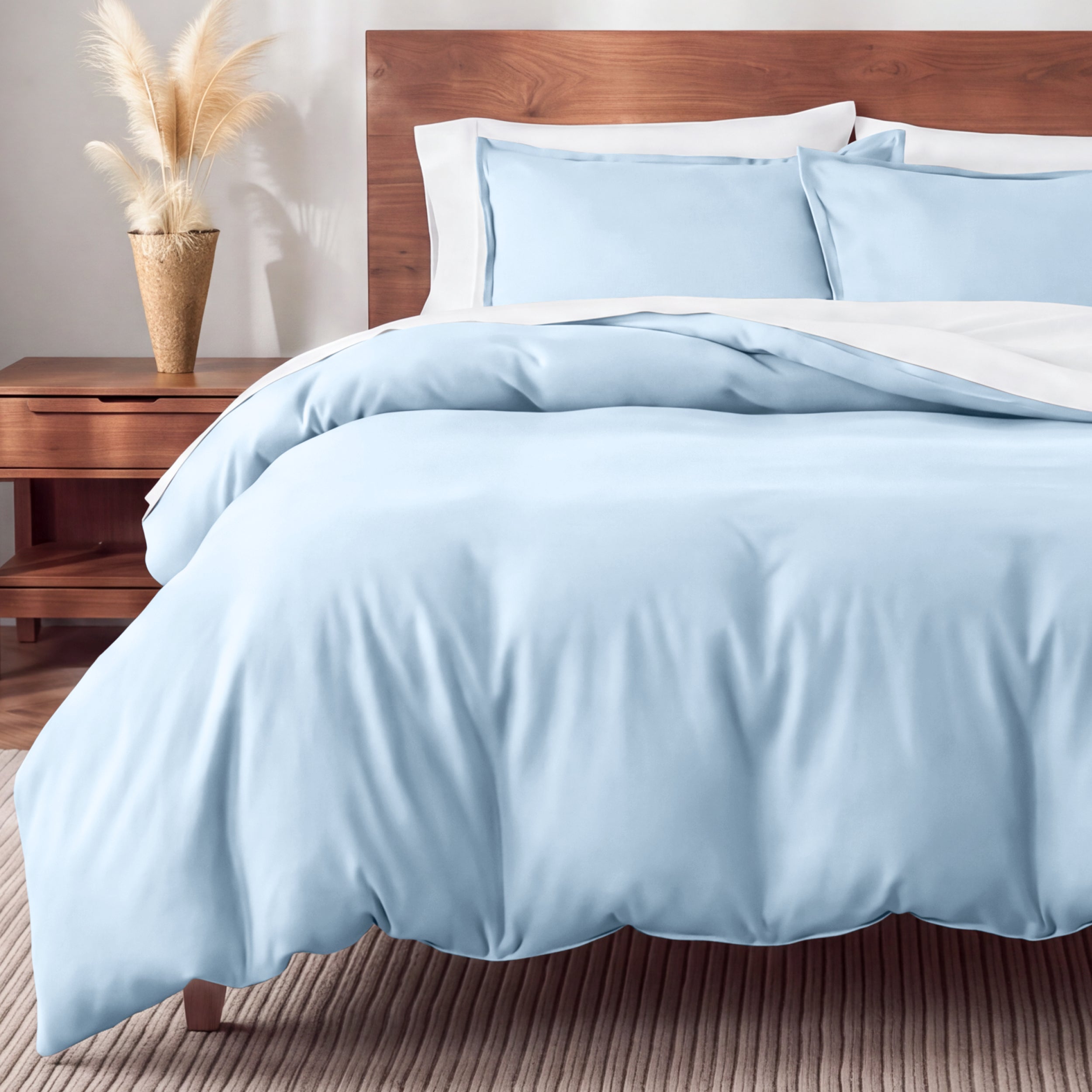 Flannel bedding set on a bed in a bedroom with a nightstand and lamp.