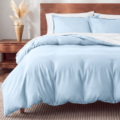 Flannel bedding set on a bed in a bedroom with a nightstand and lamp.