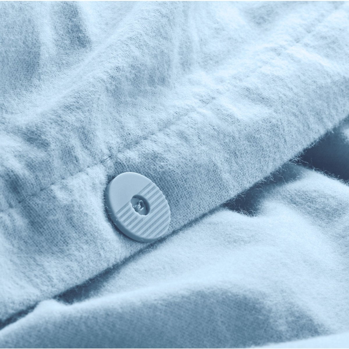 Close up of the button closure on a flannel duvet cover