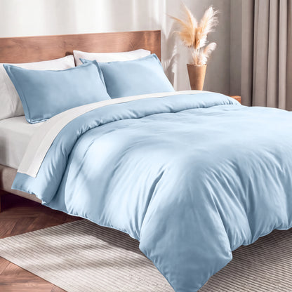 Flannel duvet cover set on a bed in a bedroom with a lamp and plant in the background.