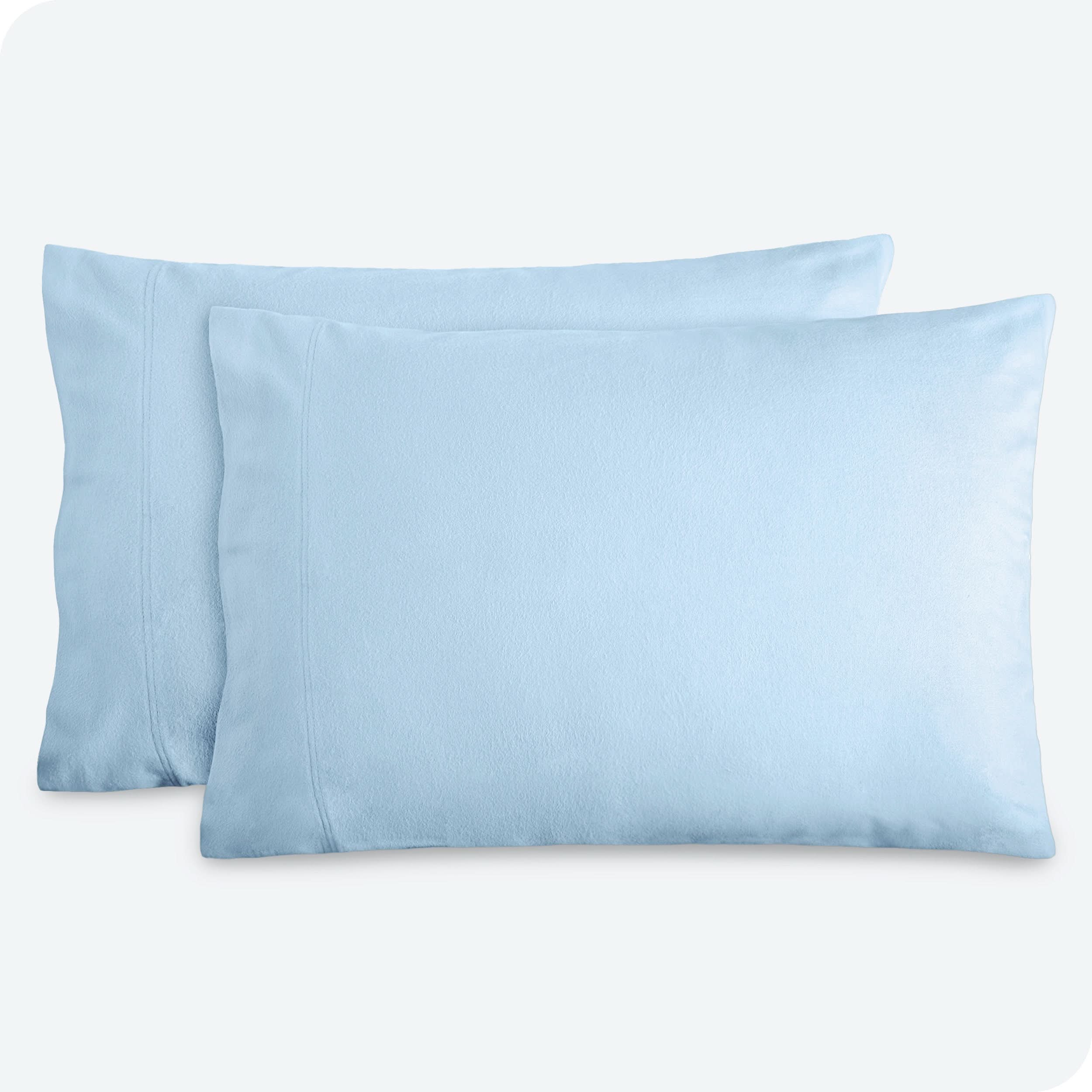 Two pillows with flannel pillowcases on them