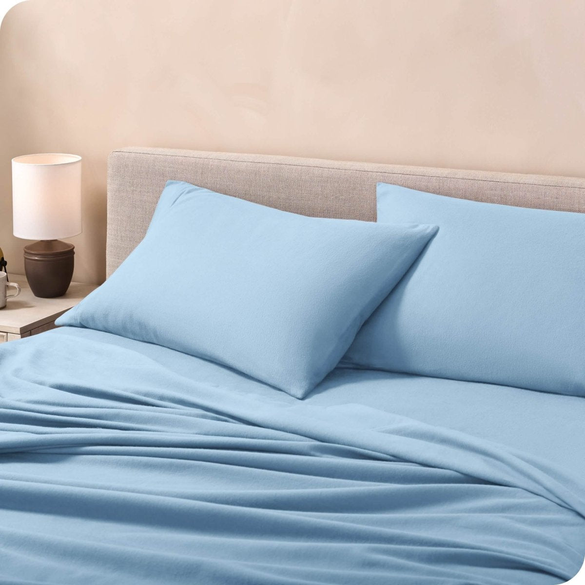 Flannel pillowcases on a mattress leaning against the headboard