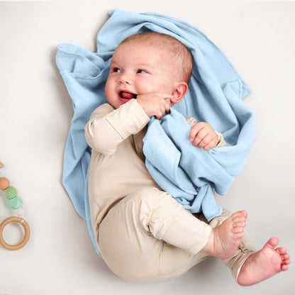 A baby lying on a flannel receiving blanket