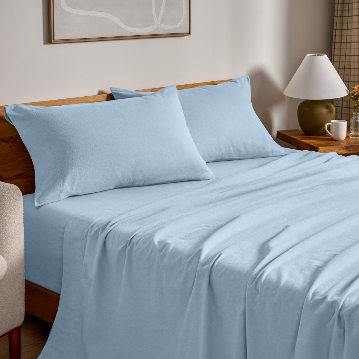Flannel bed sheets and pillowcases on a bed in a bedroom setting.
